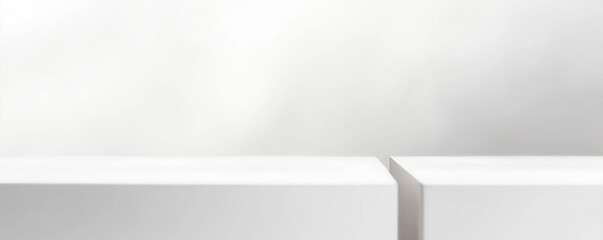Two empty white pedestals displaying products on white background