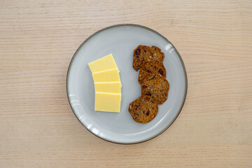 A plate of crackers and cheese.
