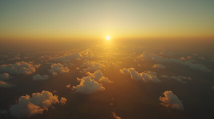 Aerial sunset view above fluffy clouds.