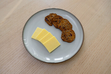 A plate of crackers and cheese.