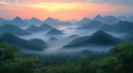 Obraz premium panoramic view of the foggy mountains at dawn, with soft hues of orange and pink in the sky