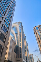 Naklejka premium Looking up at modern office buildings and local landscape