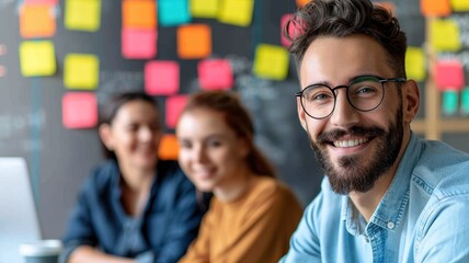 A group of young professionals collaborates in a creative workspace, with colorful sticky notes and laptops in the background, promoting a vibrant team atmosphere.