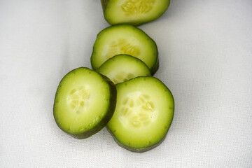 Sliced cucumber on a white background. Isolated raw vegetables background.