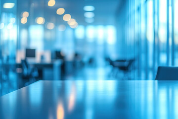 Blurred office interior with empty desk, computers, and windows in background