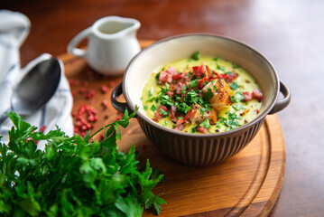 Rustic creamy soup with bacon, croutons, and parsley, celebrating comfort food and cozy dining