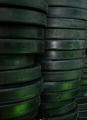 Obraz premium Stacks of weight plates arranged neatly, showcasing strength training essentials for gyms, fitness centers, and home workout spaces.