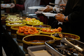 Many people buy dimsum at a shop that has various flavors, the service method is to take it yourself and then show it to the cashier. The photo was taken at night with a high angle