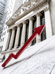 Bank building with a large red arrow pointing downward, indicating falling interest rates