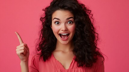 Excited woman pointing upward, surprised expression, pink background.
