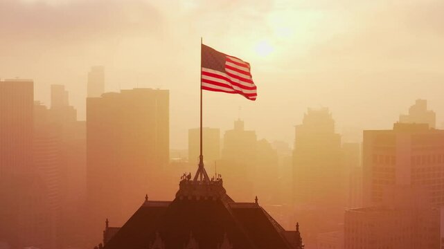 Aerial Drone Shot of American Flag Waving at Sunrise Over San Francisco Skyline and Nob Hill, California