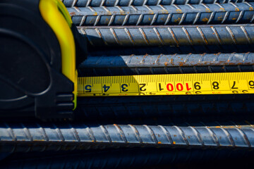 Crop worker using measuring tape at factory	