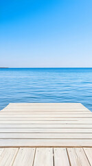 Fototapeta premium Serene lake view from wooden dock; calm water, clear sky, peaceful background; ideal for travel, relaxation, and nature themes.