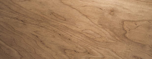 Textured wood surface displays natural patterns and warmth in a light brown hue.