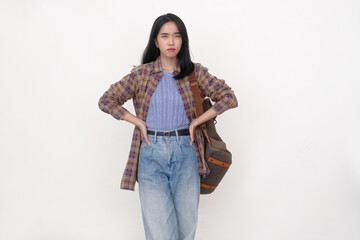 Indonesian young woman standing with both hands on her hips, facial expression is looking impatient