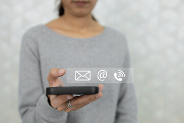 Concept of contact us. Person using smartphone finger point at contact icons. connection customer service. email, call, address. Chat message connect send and receive.