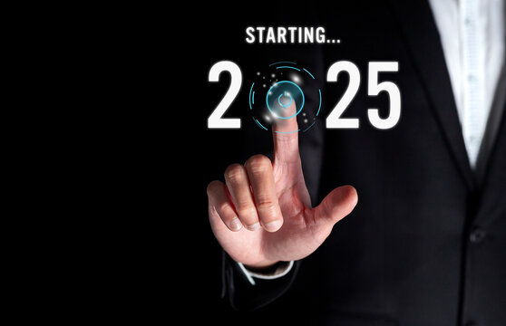 Happy new year 2025, Businessman pressing the start button for 2025 on virtual screen. Concept of planning, start, career path, business strategy, opportunity and change.