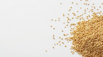 Fried quinoa scattered on a white background for culinary and health-related concepts in food photography.