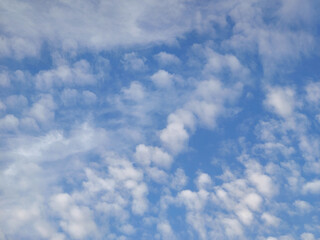 Bright blue sky with scattered white clouds