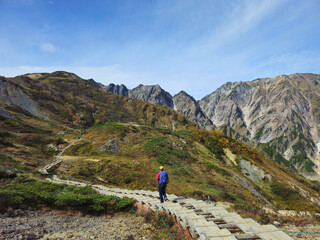 An unrecognizable man hikes towards Happo Pond in the mountains of Hakuba, Nagano prefecture, Japan. 