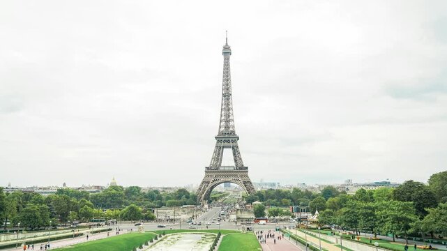 A stunning view of the Eiffel Tower, framed by lush greenery and vibrant city life, showcasing the beauty of Paris.