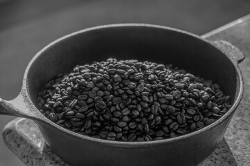 Cast iron skillet with roasted coffee beans