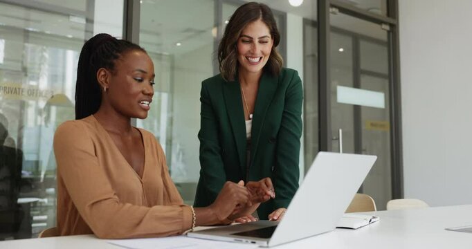 Two professional women engage in moment of celebration and teamwork, working on joint task using laptop, exchange high-five, gesture of successful collaboration, shared achievement, or resolved task