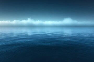 Fototapeta premium Calm ocean at dawn with low clouds.