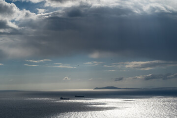 beautiful high angle view of the Gibraltar straight, boats and Africa with a magnificent cloud above the sea