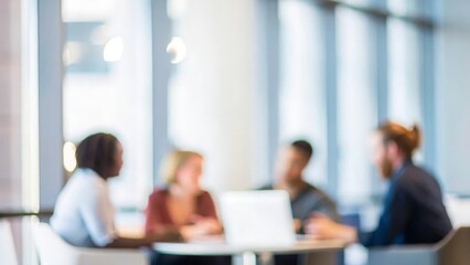 A blurred background of professionals collaborating in a modern workplace.

