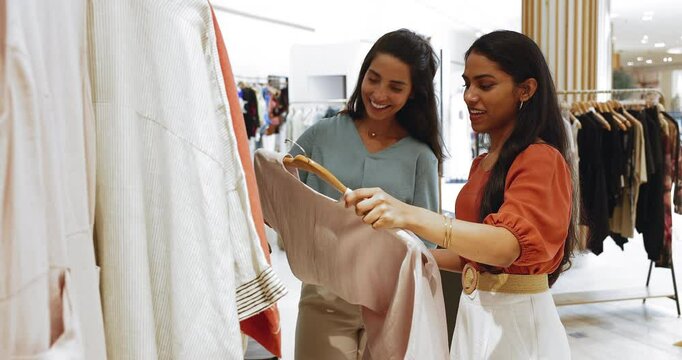 Friendly interaction between shop consultant and client in fashion store. Female receive personalized customer care, get styling advice and recommendations during visit in modern boutique. Shopping