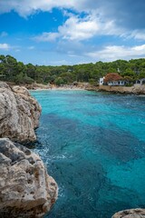 Scenic coastal landscape with turquoise water and rocky cliffs.
