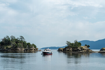 Boat along shore of Sucia Island in the San Juan Islands in the Pacific Northwest in Washington 
