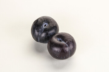 Two ripe sweet black plums