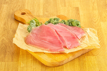 Raw salted tuna slice over board