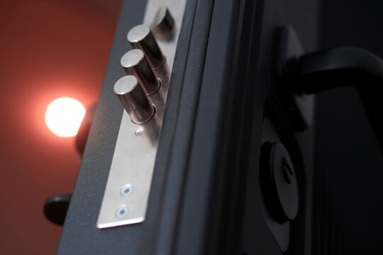 Modern extreme armored entrance door with extended door lock bolts. Locking mechanism on a mortise lock. Actual protection of an apartment and a house. Photo. Selective focus