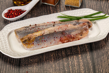 Salted marinated herring fillet with spices