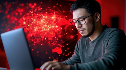 Focused Man Working on Laptop with Red Digital World Map Background