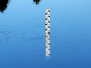 A water level meter in the lake shows the water level and is visible to everyone and is used to...