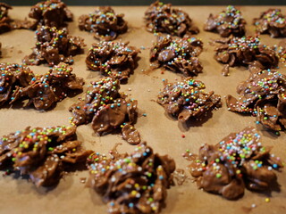Chocolate crossies, homemade from cornflakes and chocolate, garnished with colorful sprinkles....