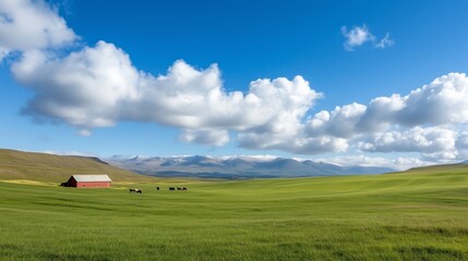 Obraz premium Peaceful countryside with red barn, grazing cows, and majestic mountains