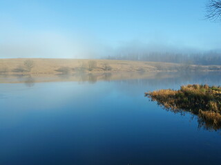 A mystical mining pond in the Harz. Fog, reflections, and horizons in winter create an enigmatic atmosphere, perfect for diverse themes.