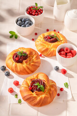 Fresh and hot berries yeast cake with crumble and fruits.
