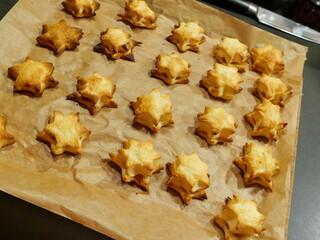 Baked puff pastry cookies with apple filling shaped like Christmas stars, a delicious and popular...
