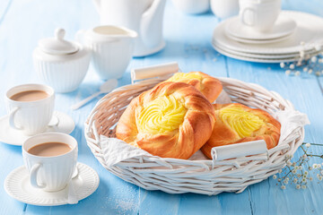 Sweet cheese yeast bun served with coffee in porcelain..