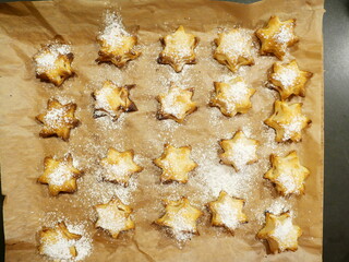 Baked puff pastry cookies with apple filling shaped like Christmas stars, a delicious and popular treat, perfect for holidays and festive occasions.