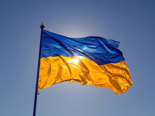 Ukrainian flag waving against a bright blue sky