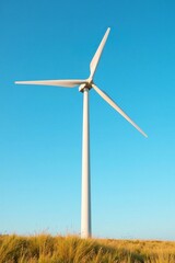 Fototapeta premium Windmill blades spin in the breeze against a clear blue sky, windmill, blades