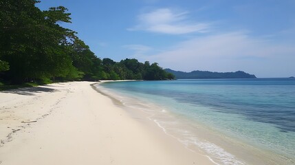 5. An empty white sandy beach with clear blue ocean water, perfect for relaxation under the sun