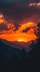 Fototapeta premium Fiery Sunset Behind Mountain Range